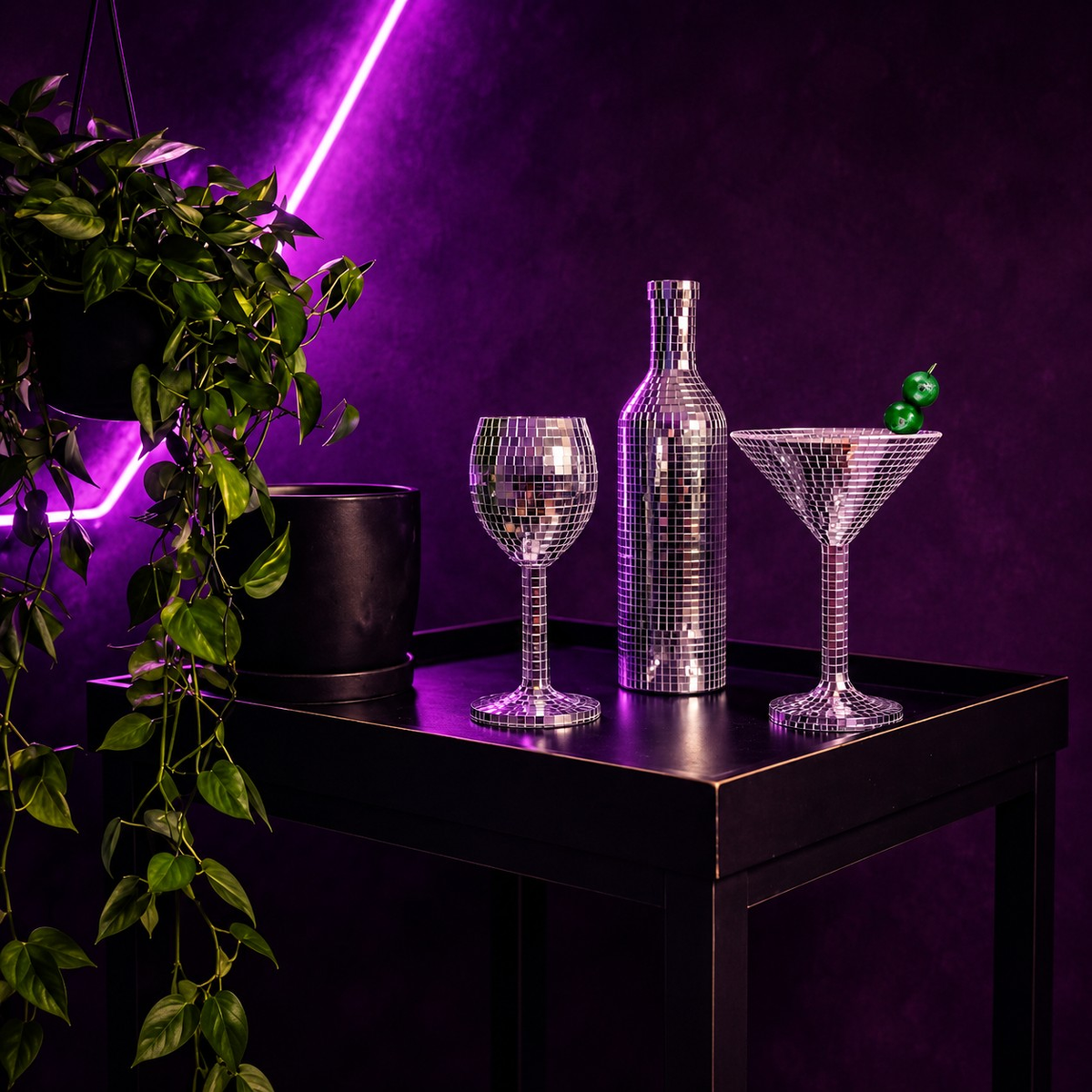 Silver mirror wine glass, wine bottle and martini glass on a purple-lit table