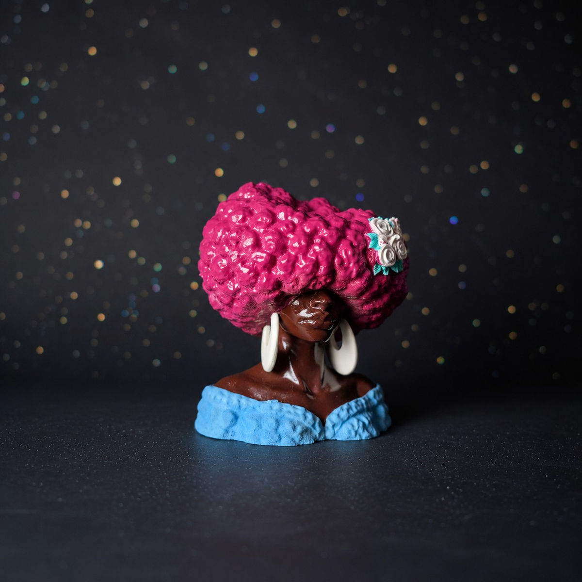 Girl Juice sculptural head planter with pink textured hair, blue dress and white flower detail