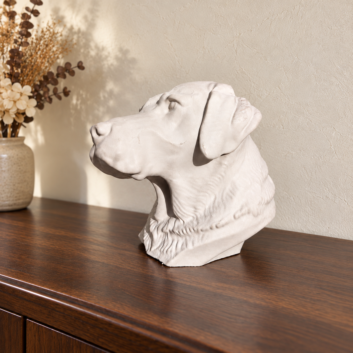 Chalk off-white Labrador urn in side profile on a walnut surface