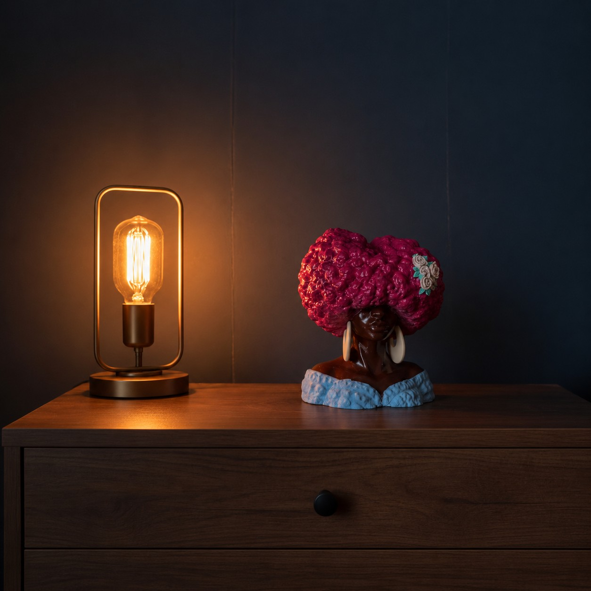 Girl Juice head planter styled on a wooden shelf beside a warm table lamp