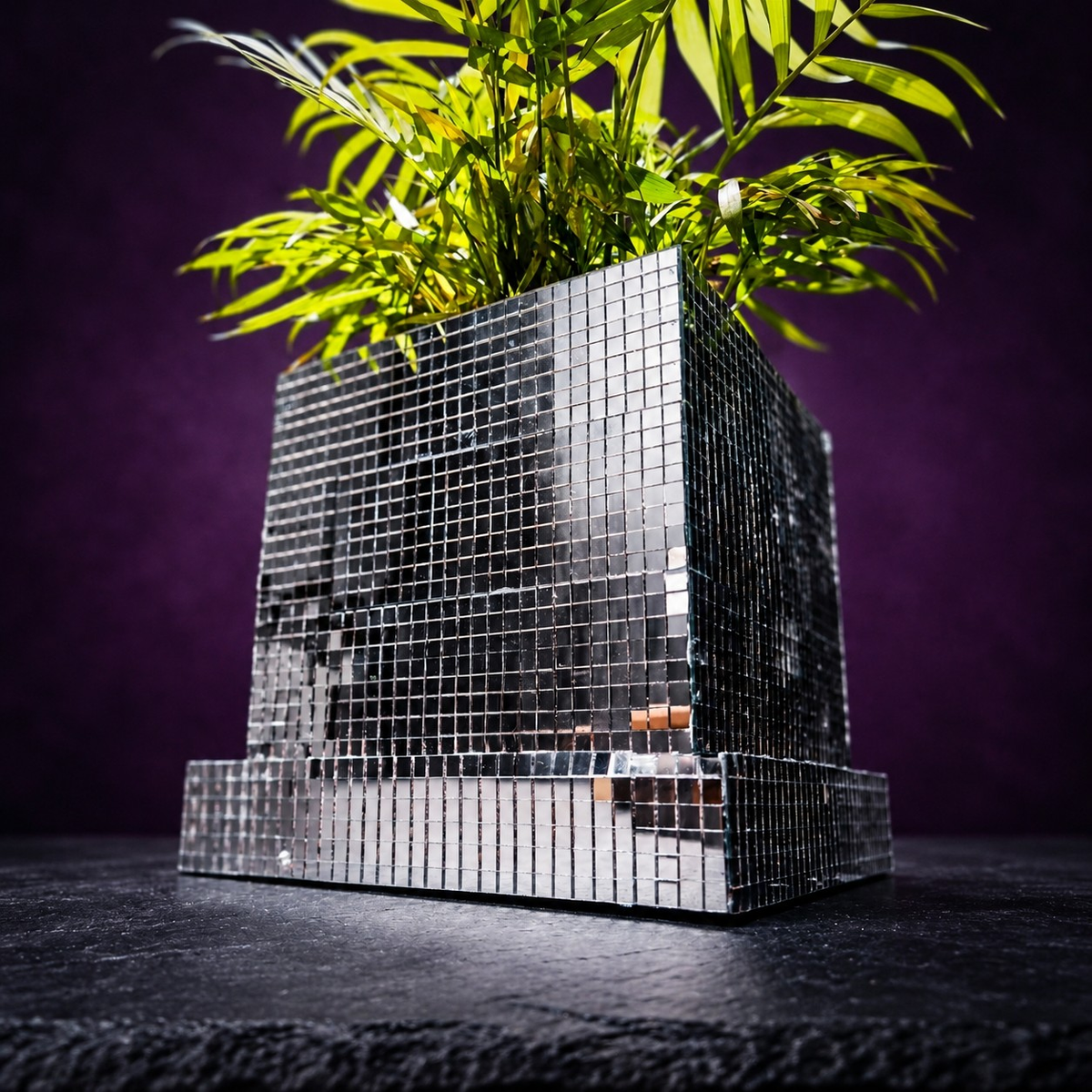 Close-up of mirror tile disco cube planter with palm fronds