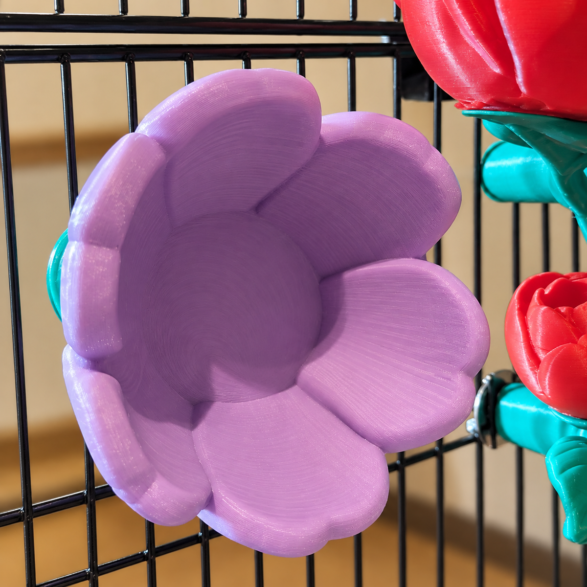 Close view of a purple flower forage cup and its cage mount