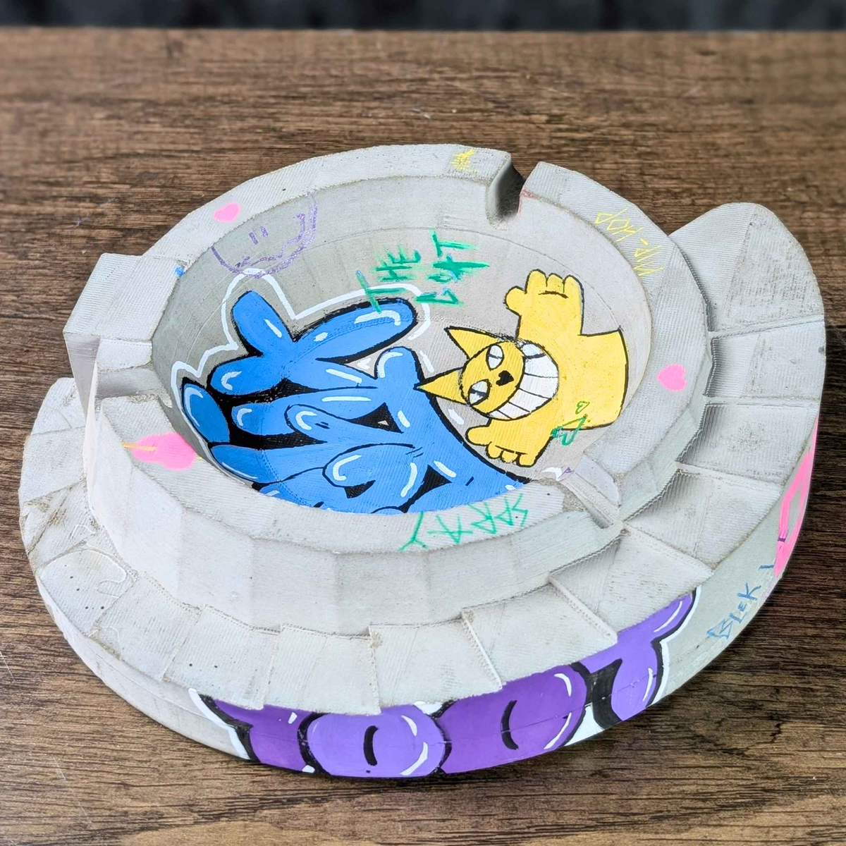 Top angle of custom graffiti ashtray showing blue and yellow artwork