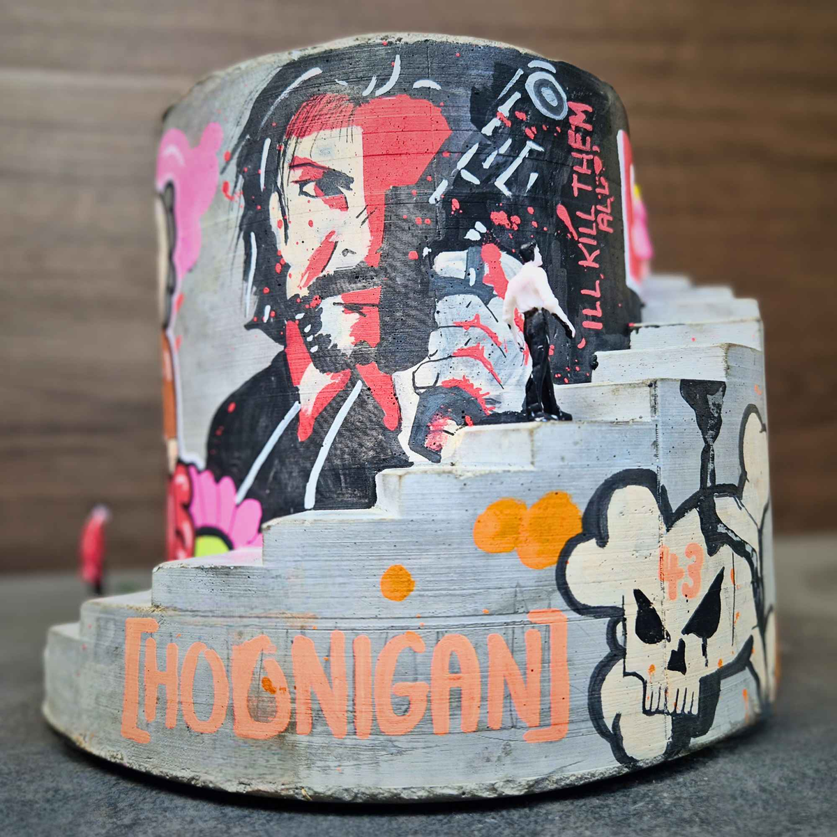 Hoonigan-themed graffiti stairwell planter with portrait and skull artwork