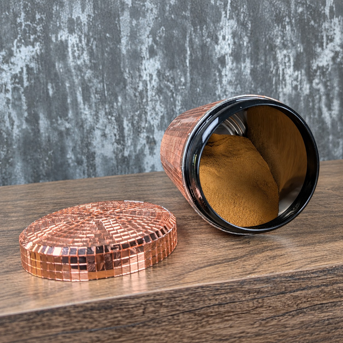 Open rose gold mirror canister with detached lid showing the metal interior
