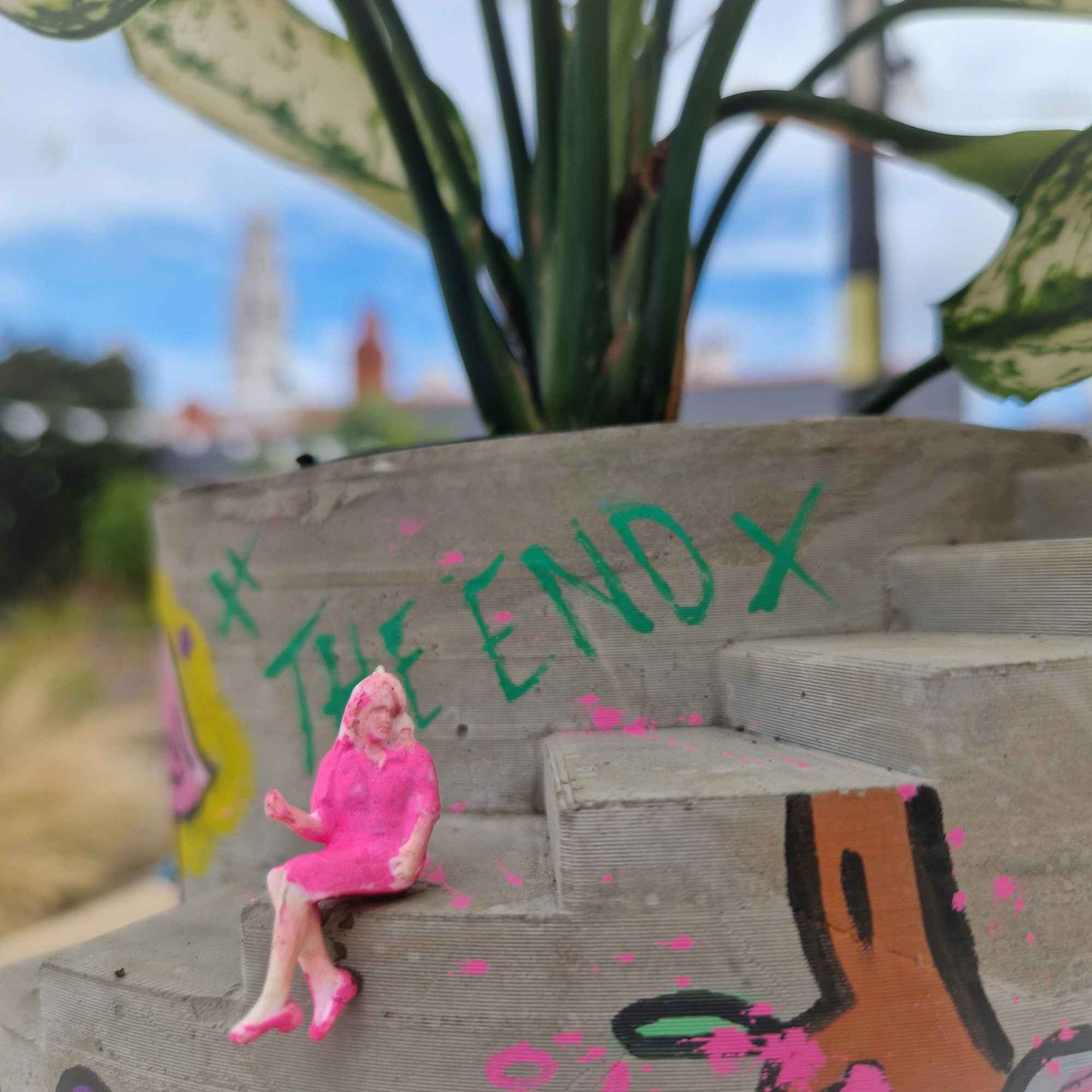 Close-up of miniature figure and painted details on planter steps