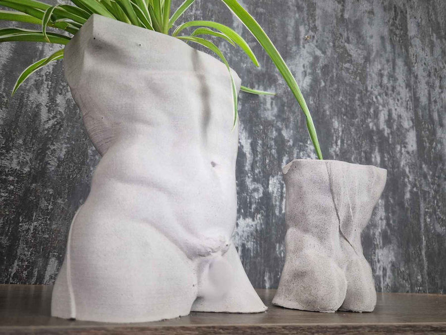 Large planted Greek god male torso planter beside a smaller unplanted planter