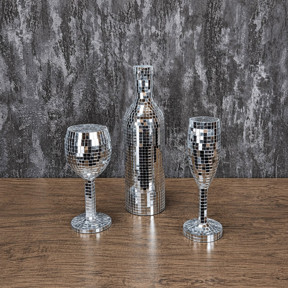 Silver mirror wine glass, bottle and champagne flute, front view