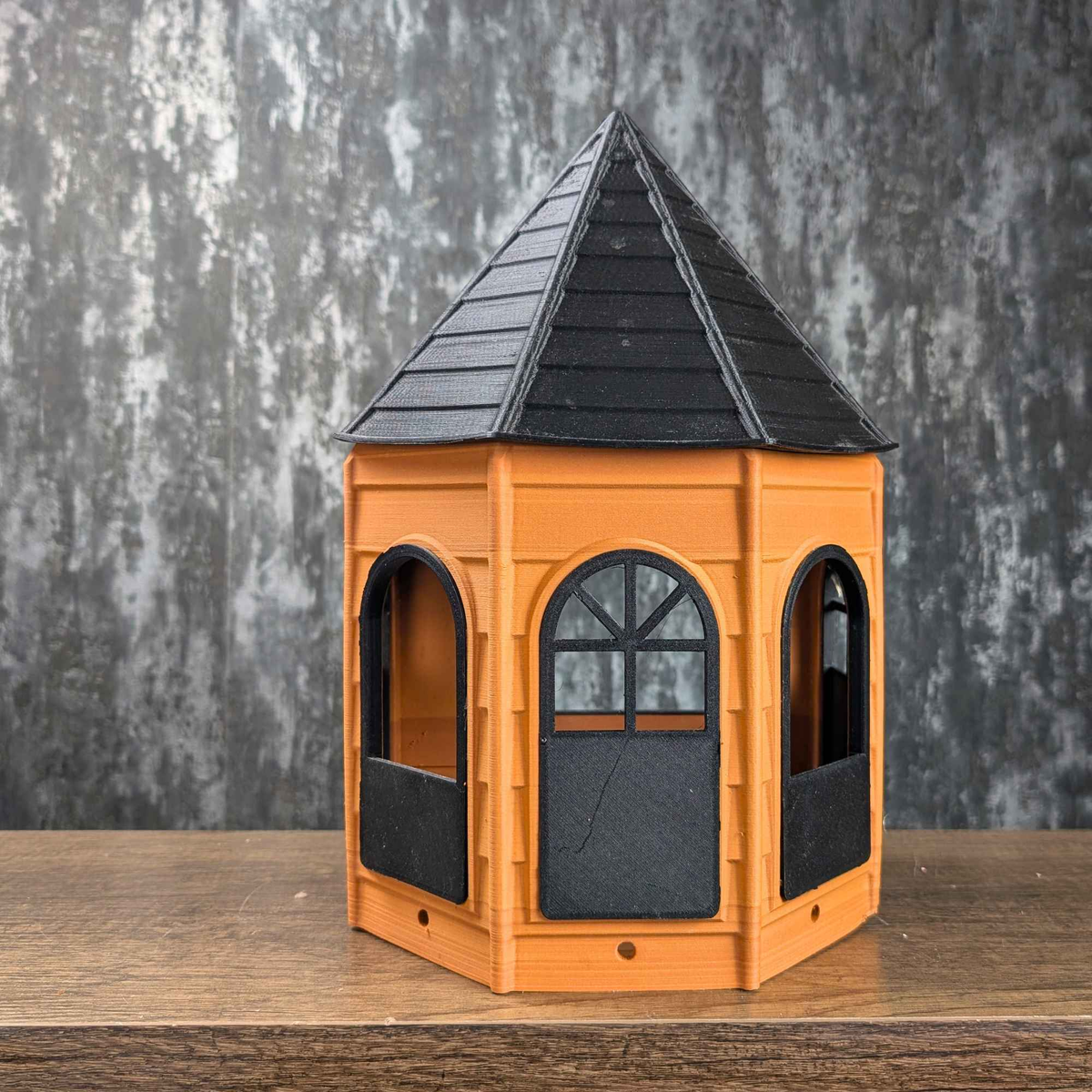 Empty orange and black Rat Mansion hide, front studio view