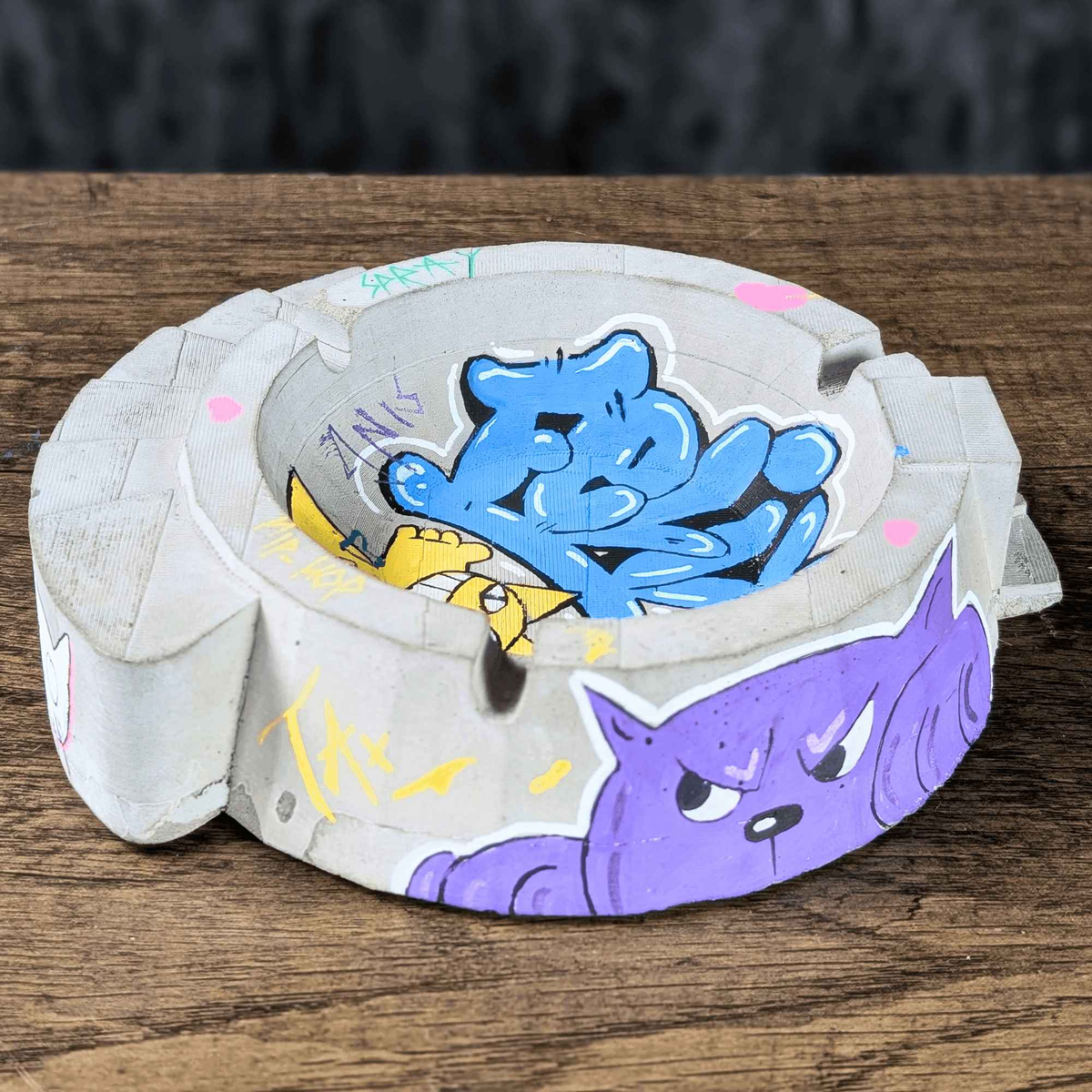 Custom graffiti ashtray with blue lettering and purple cat artwork