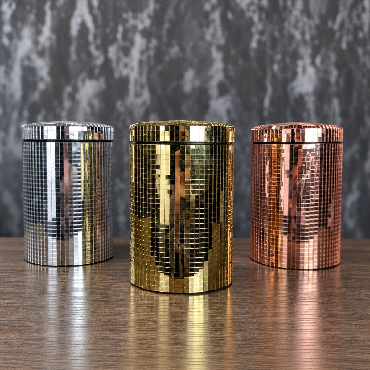 Silver, gold and rose gold mirror kitchen canisters shown front-on