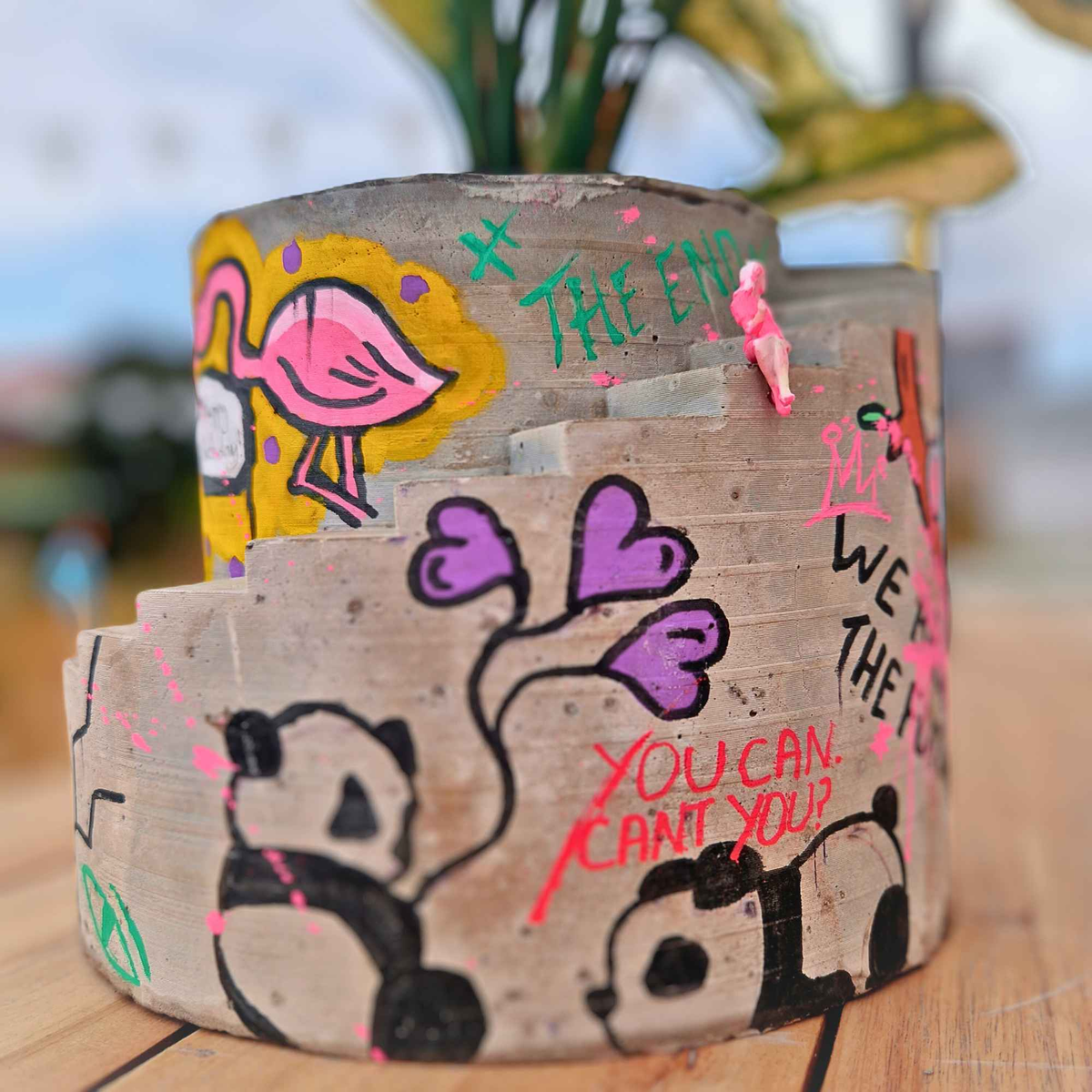 Custom graffiti stairwell planter with flamingo artwork and painted messages