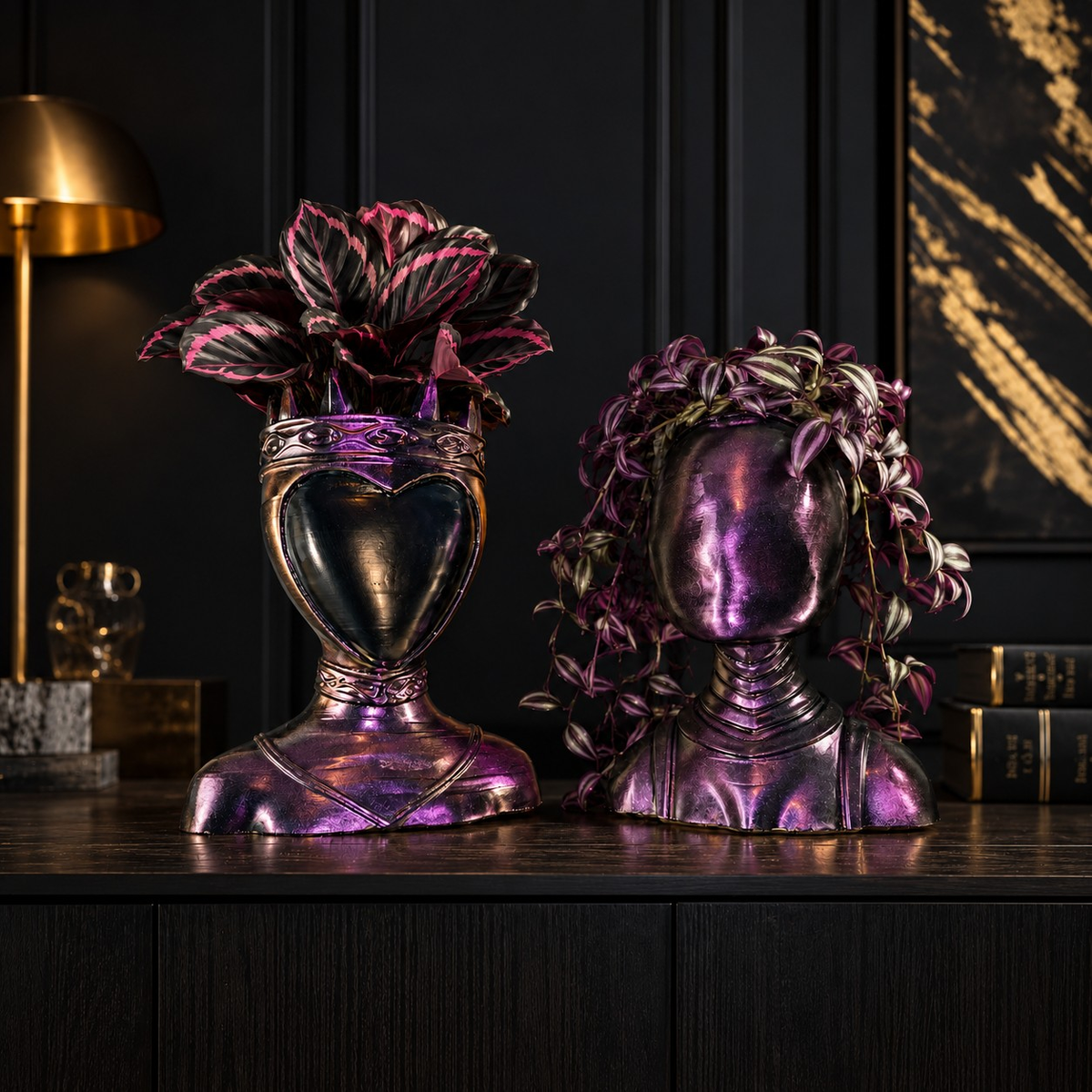 Queen and Oracle cast stone bust planters on dark interior shelf