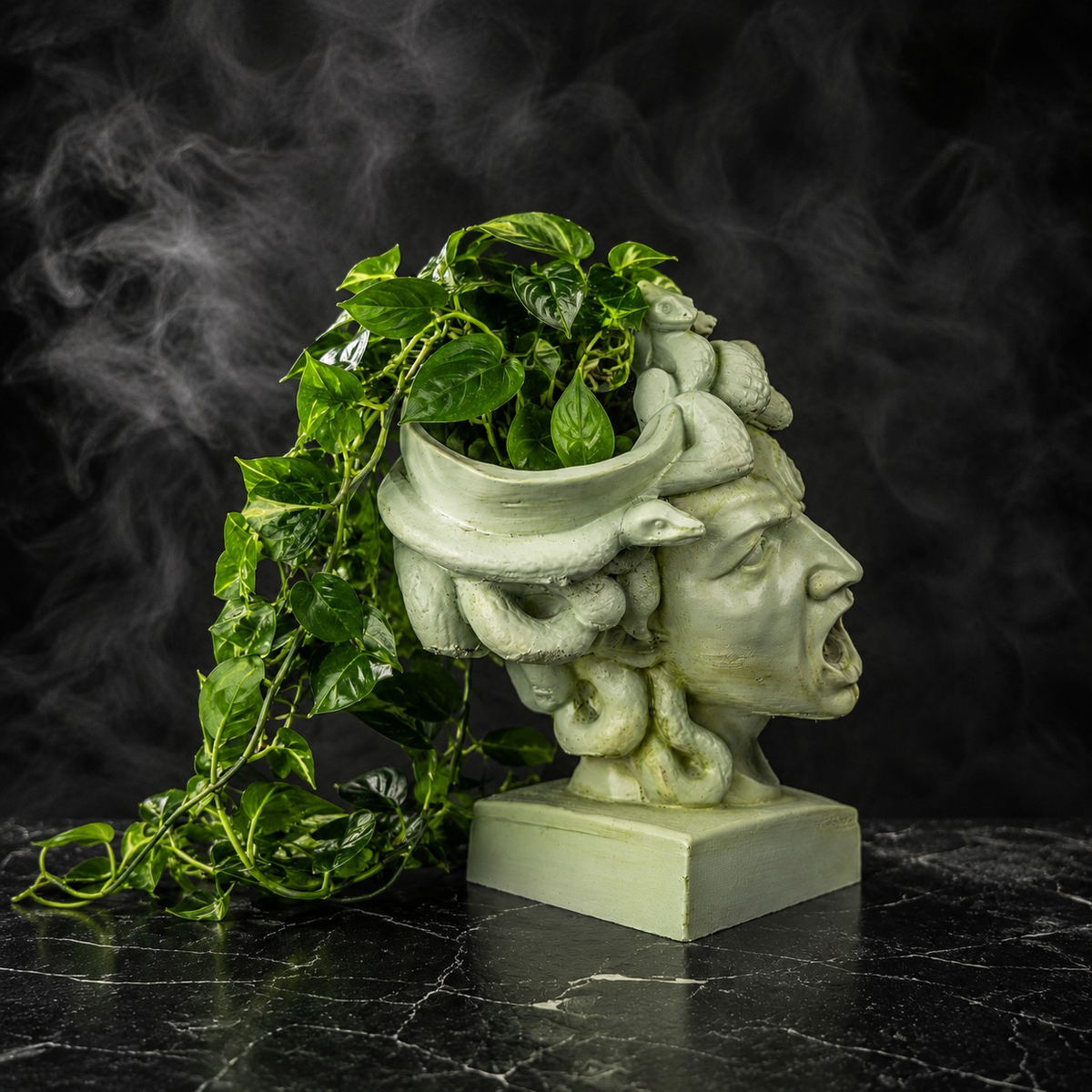 The Gorgon's Bloom Medusa cast stone planter with trailing green plant