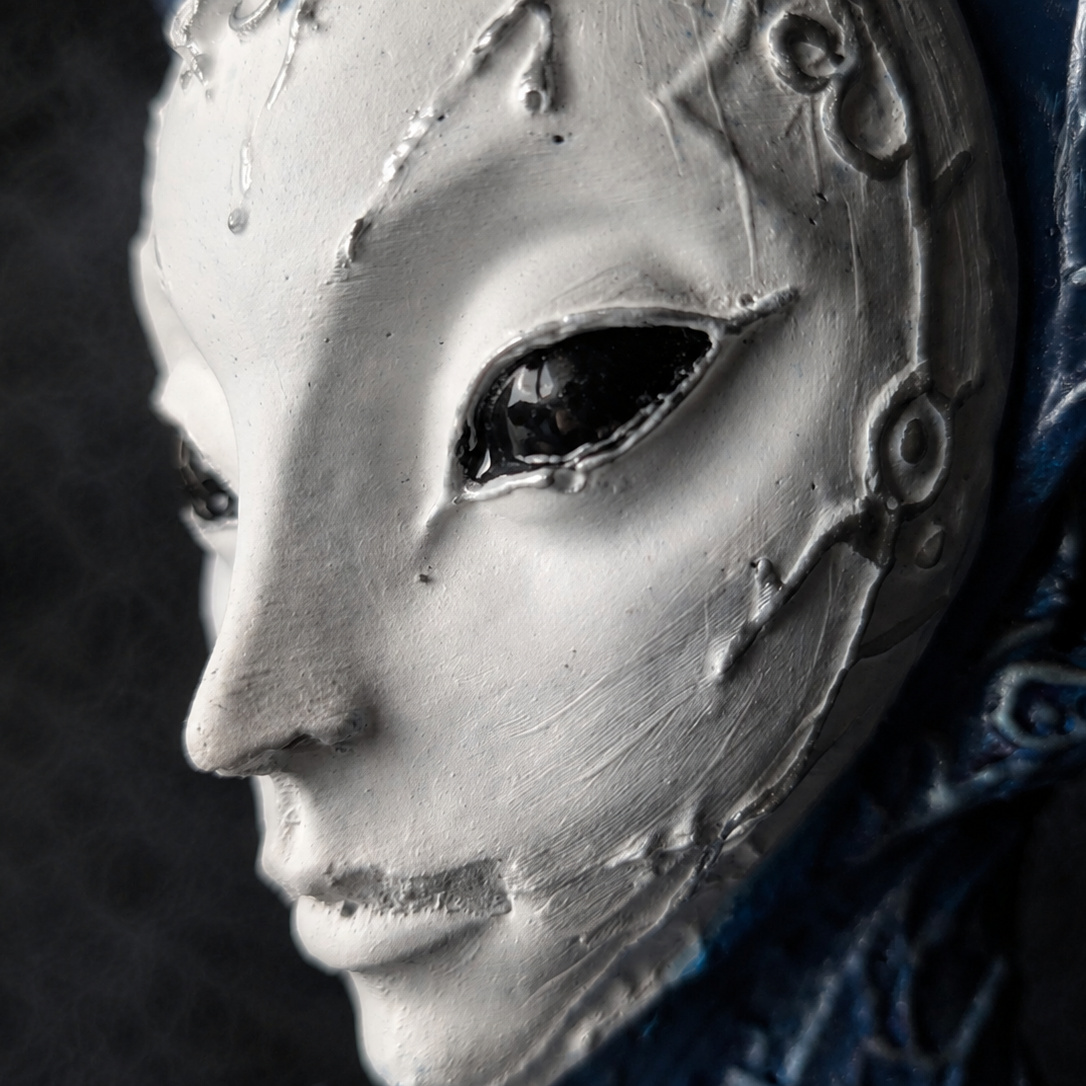 Close detail of The Blue Trickster alien planter face and blue headdress