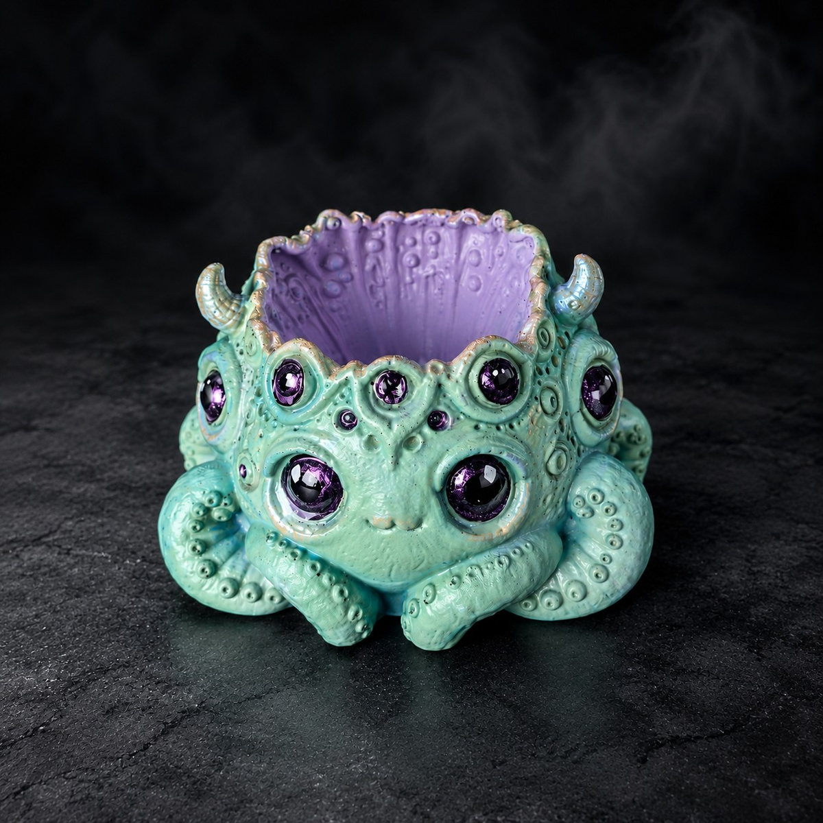 Noodle many eyed monster plant pot showing purple interior and tentacle detail
