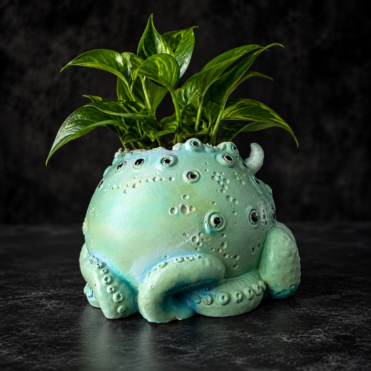 Back view of Noodle cast stone tentacle plant pot with raised eye detail