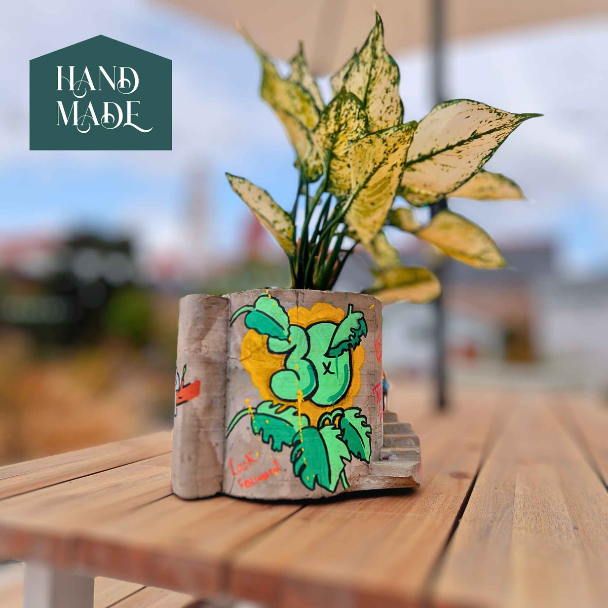 Planted graffiti stairwell planter with orange carrot artwork