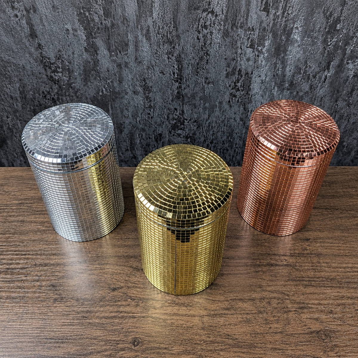 Three mirror-tiled kitchen canisters angled to show gold, rose gold and silver finishes