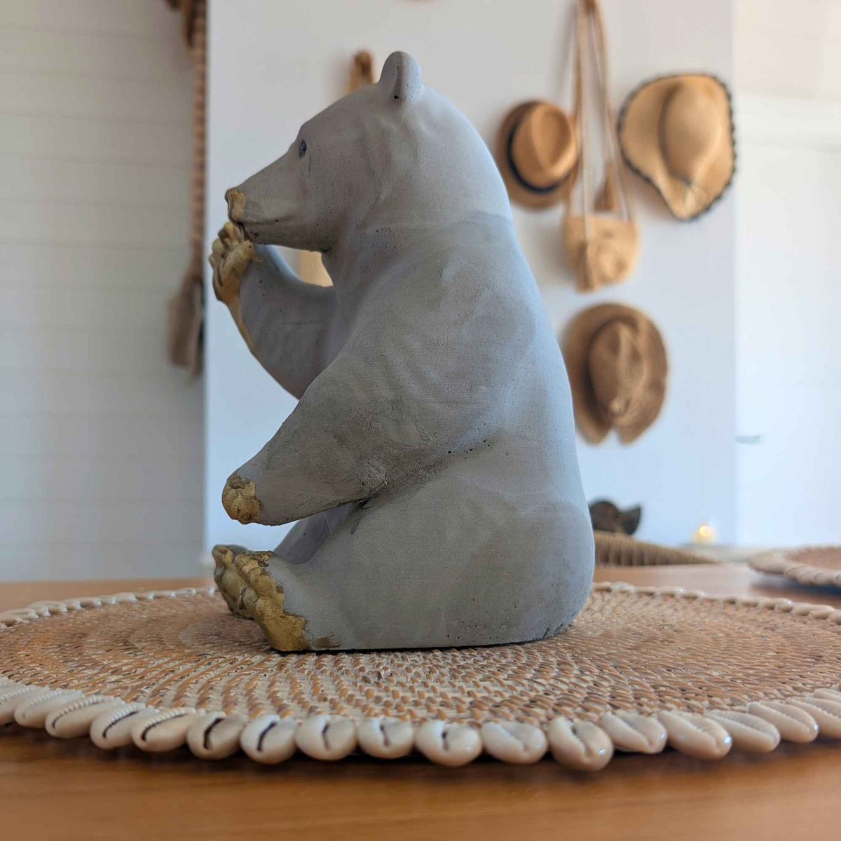 Side profile of honey bear garden ornament on a woven table mat