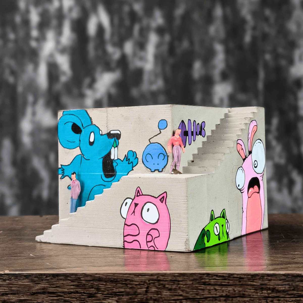 Empty graffiti building planter showing colourful cartoon murals on two sides