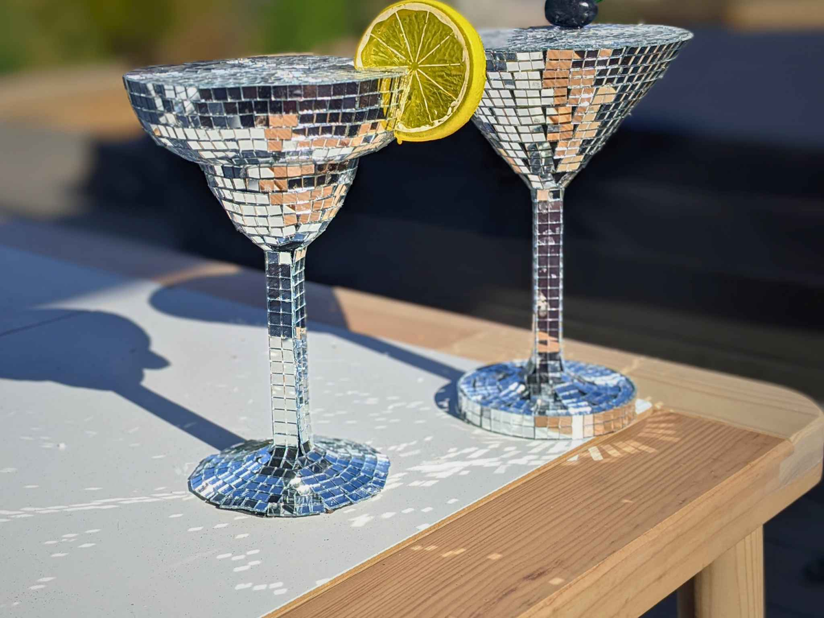 Close-up of silver mirror margarita and martini glasses outdoors