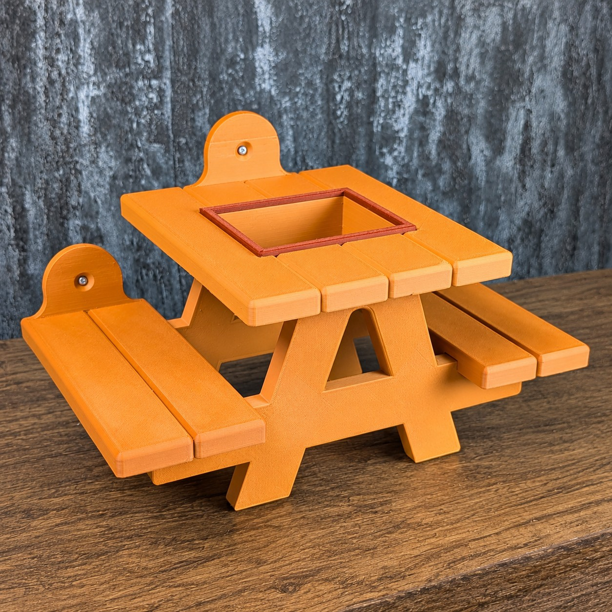 Orange rat picnic bench shown without the removable food bowl