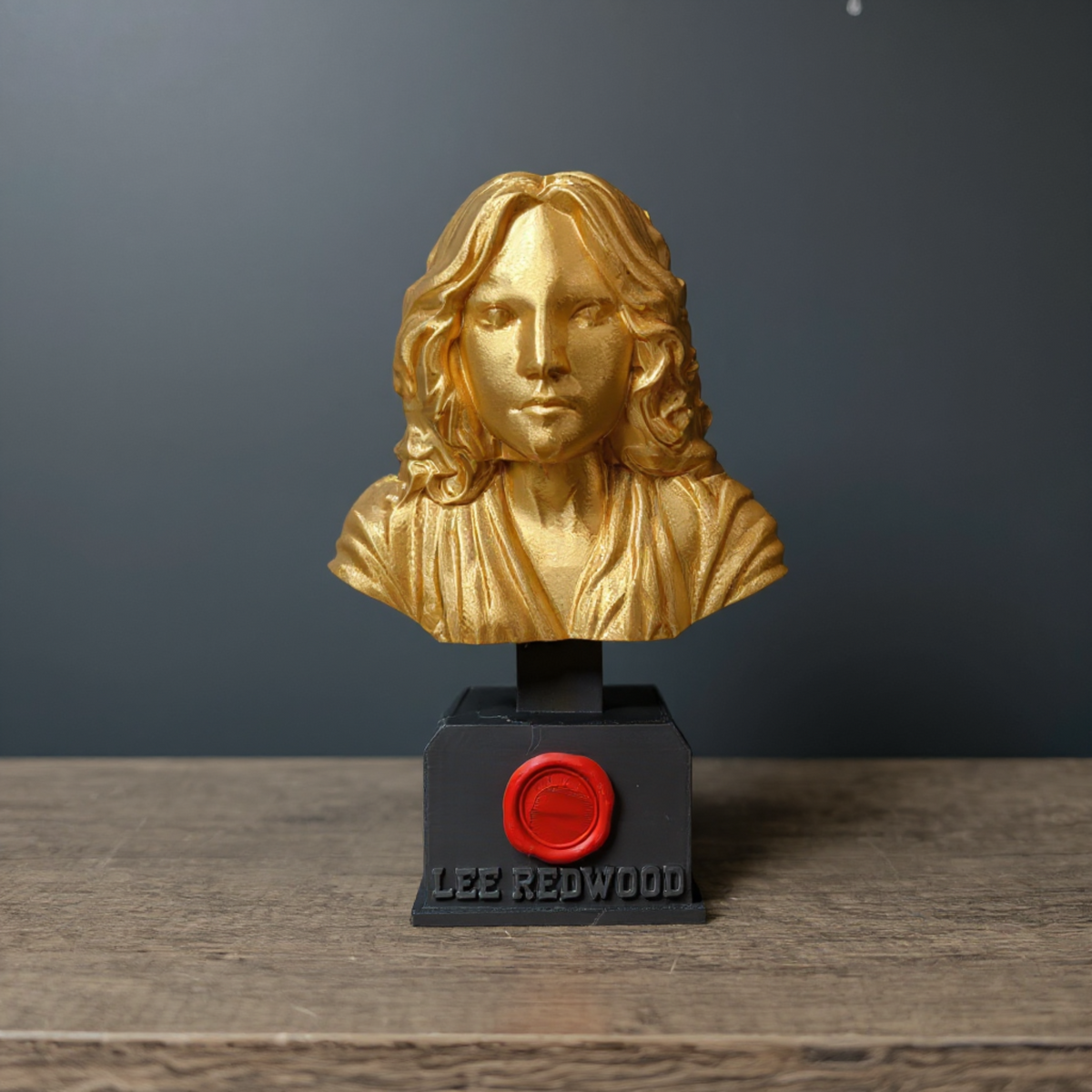 Front view of a personalised gold bust trophy engraved Lee Redwood