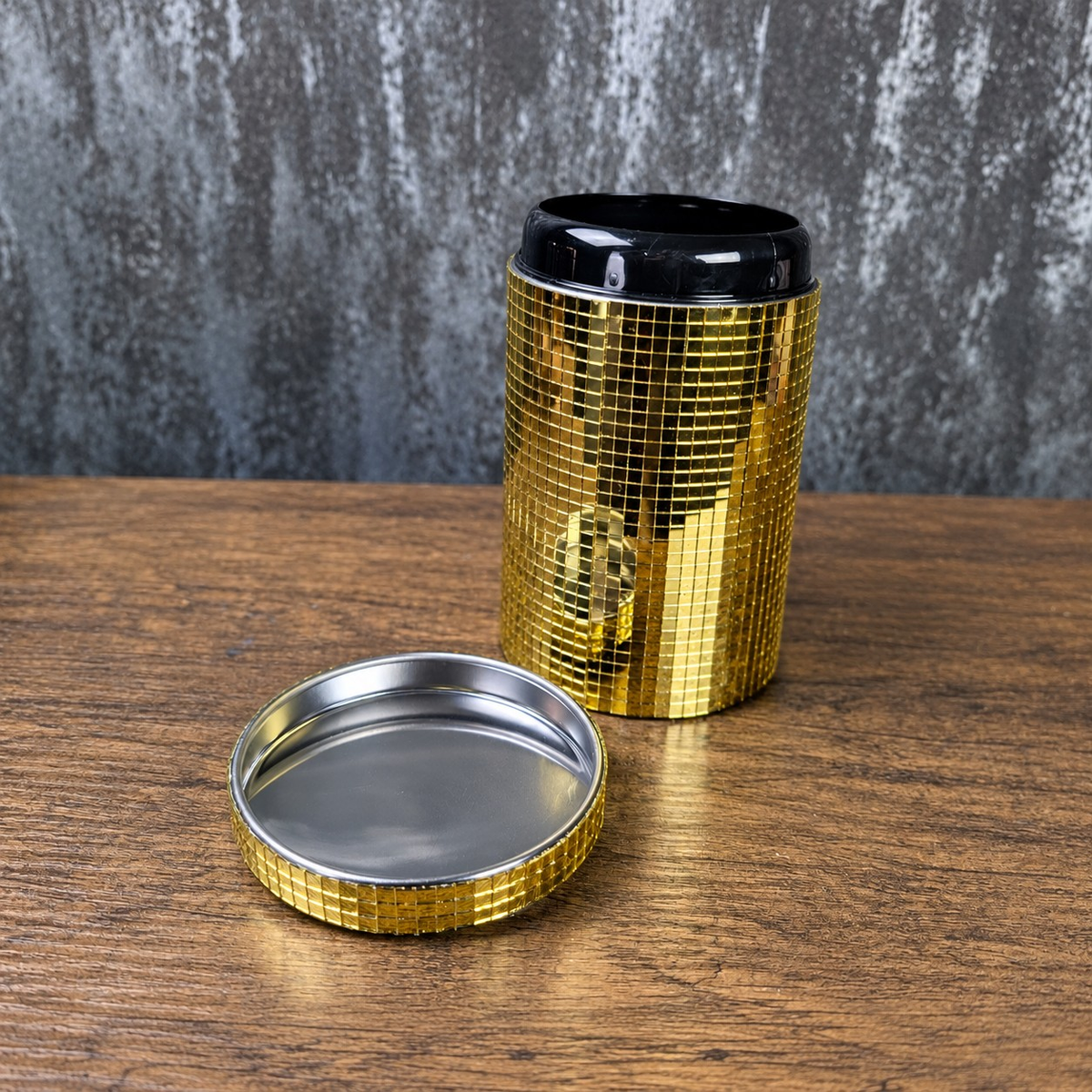 Open gold mirror canister with detached lid showing the metal interior