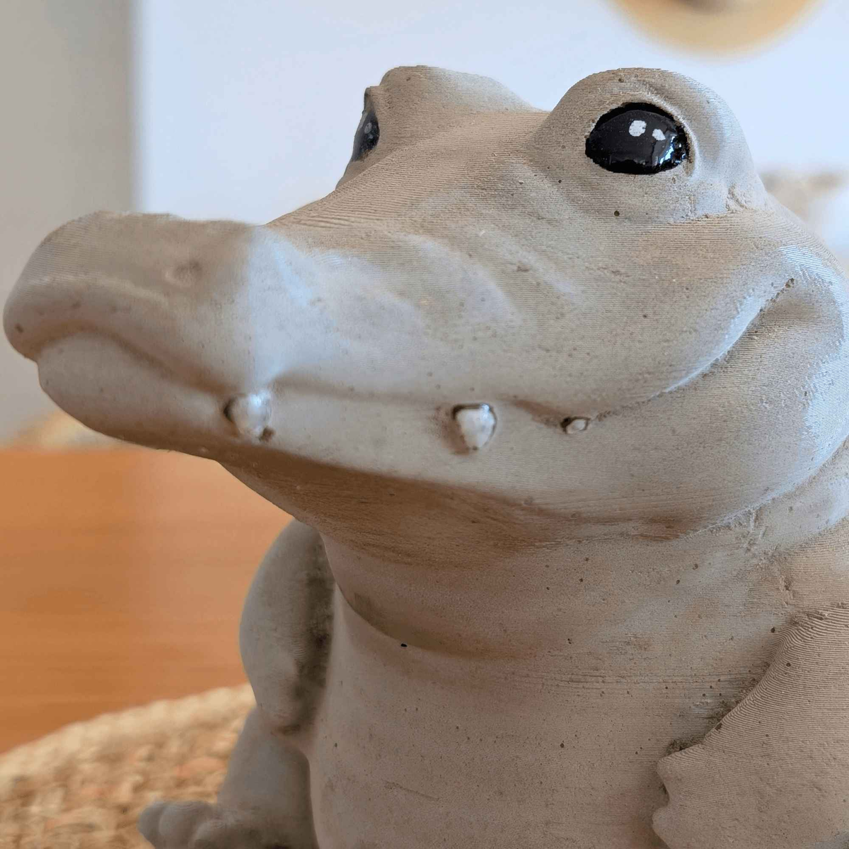 Close-up of the crocodile ornament's face, eyes and small teeth