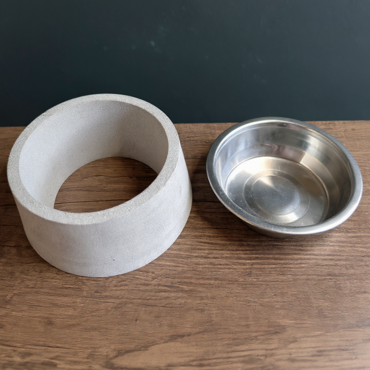 Removable steel feeding insert beside the empty cast stone bowl base
