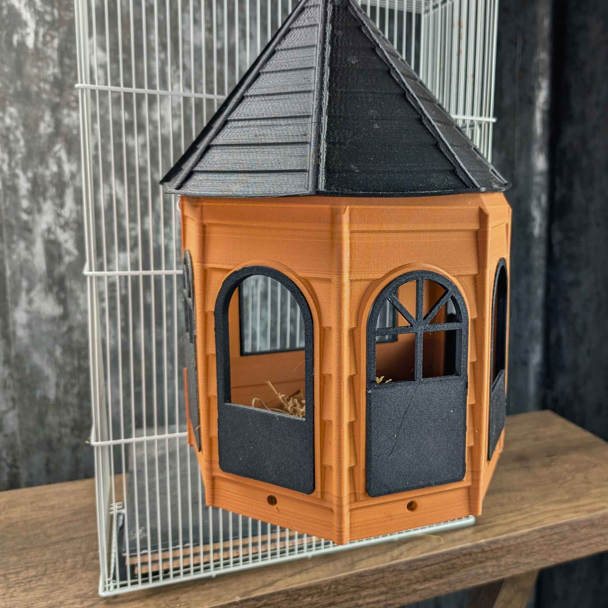 Orange Rat Mansion hide mounted to cage bars, three-quarter view