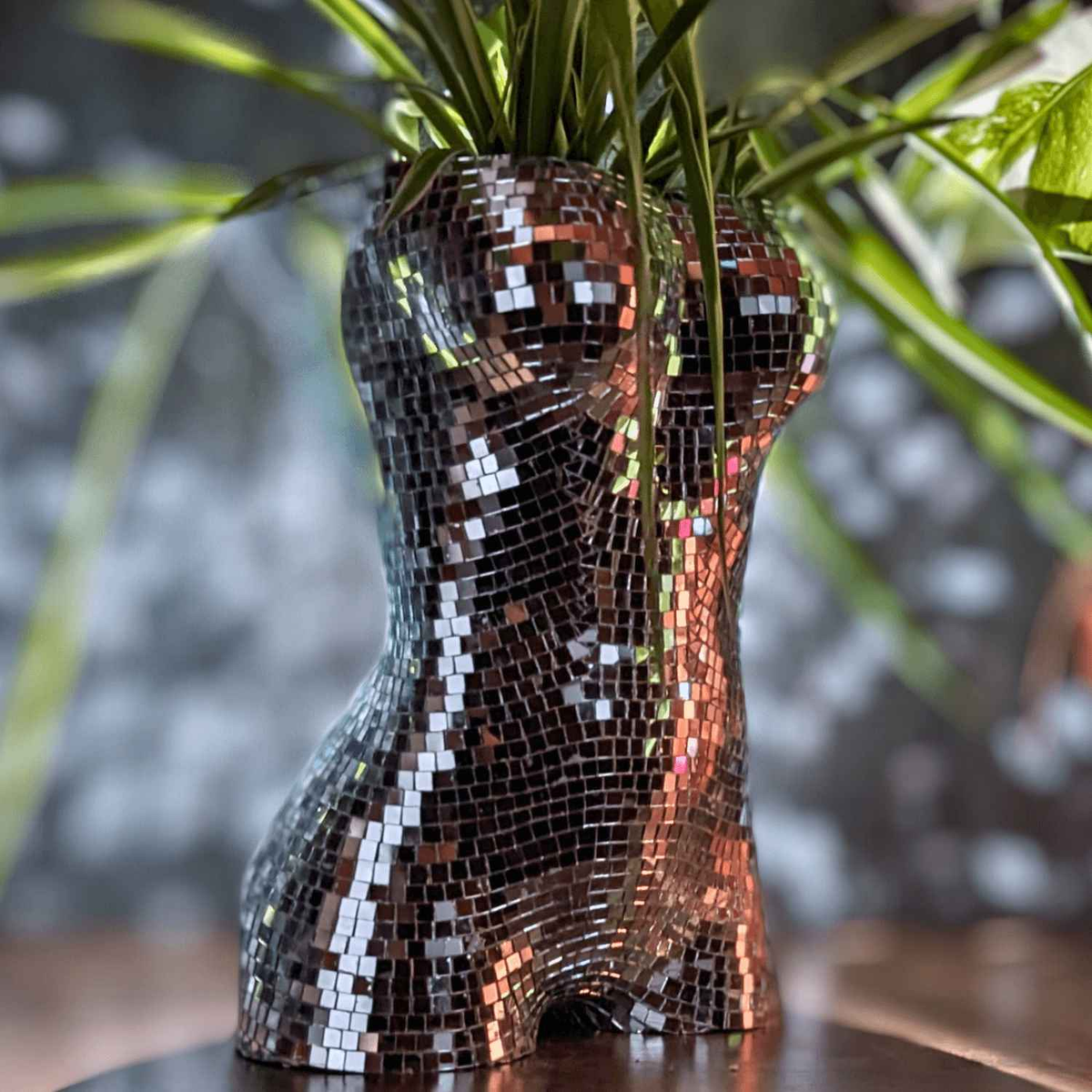 Close-up of silver glass mirror tiles on the torso planter