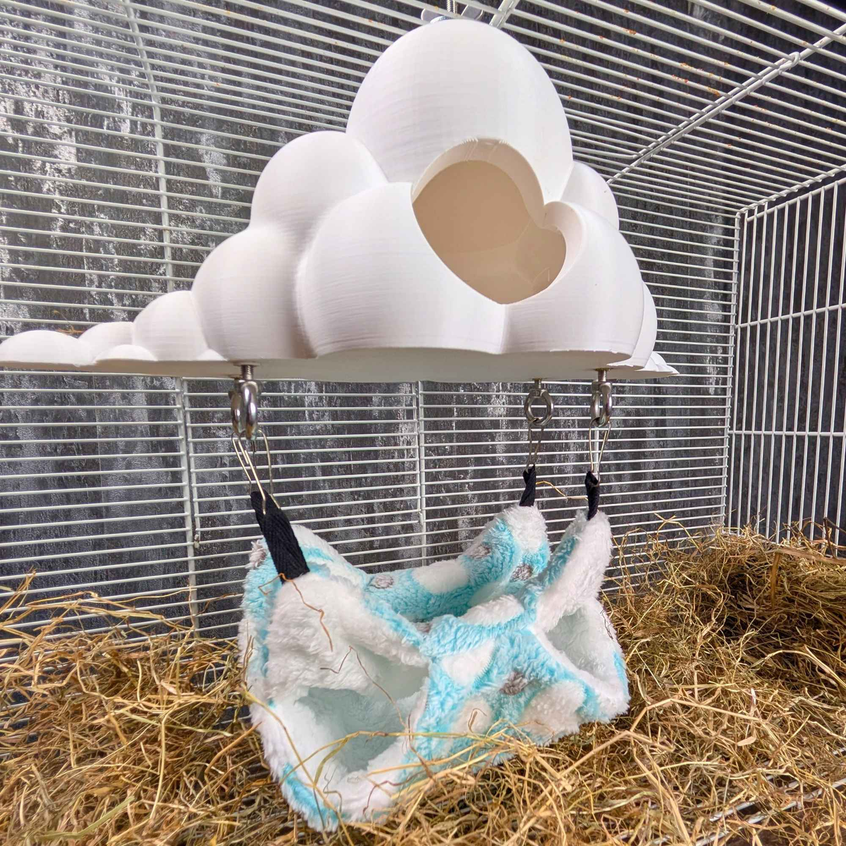 Wide cage view of the cloud hide and hammock set above nesting hay