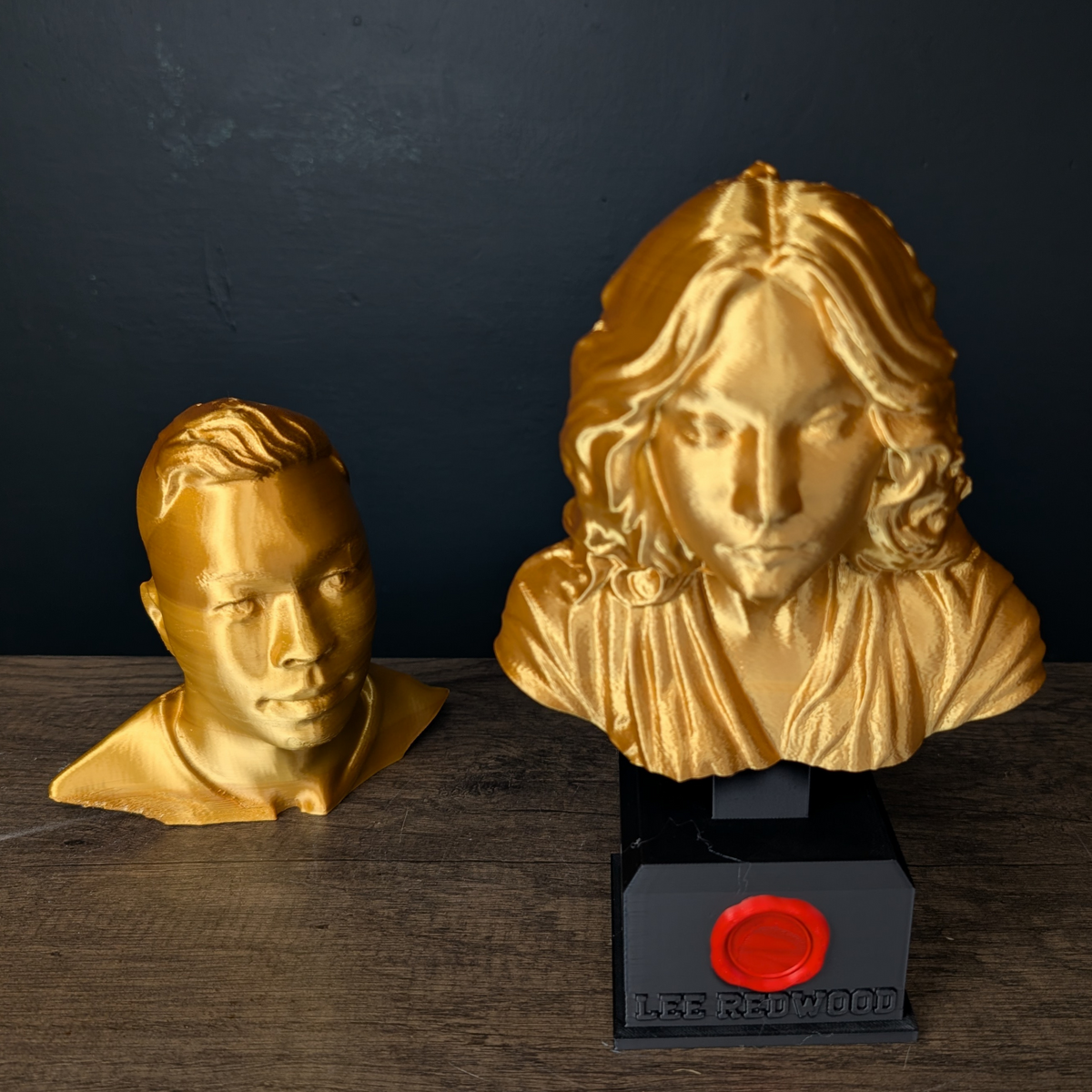 Two different gold custom portrait bust examples shown together