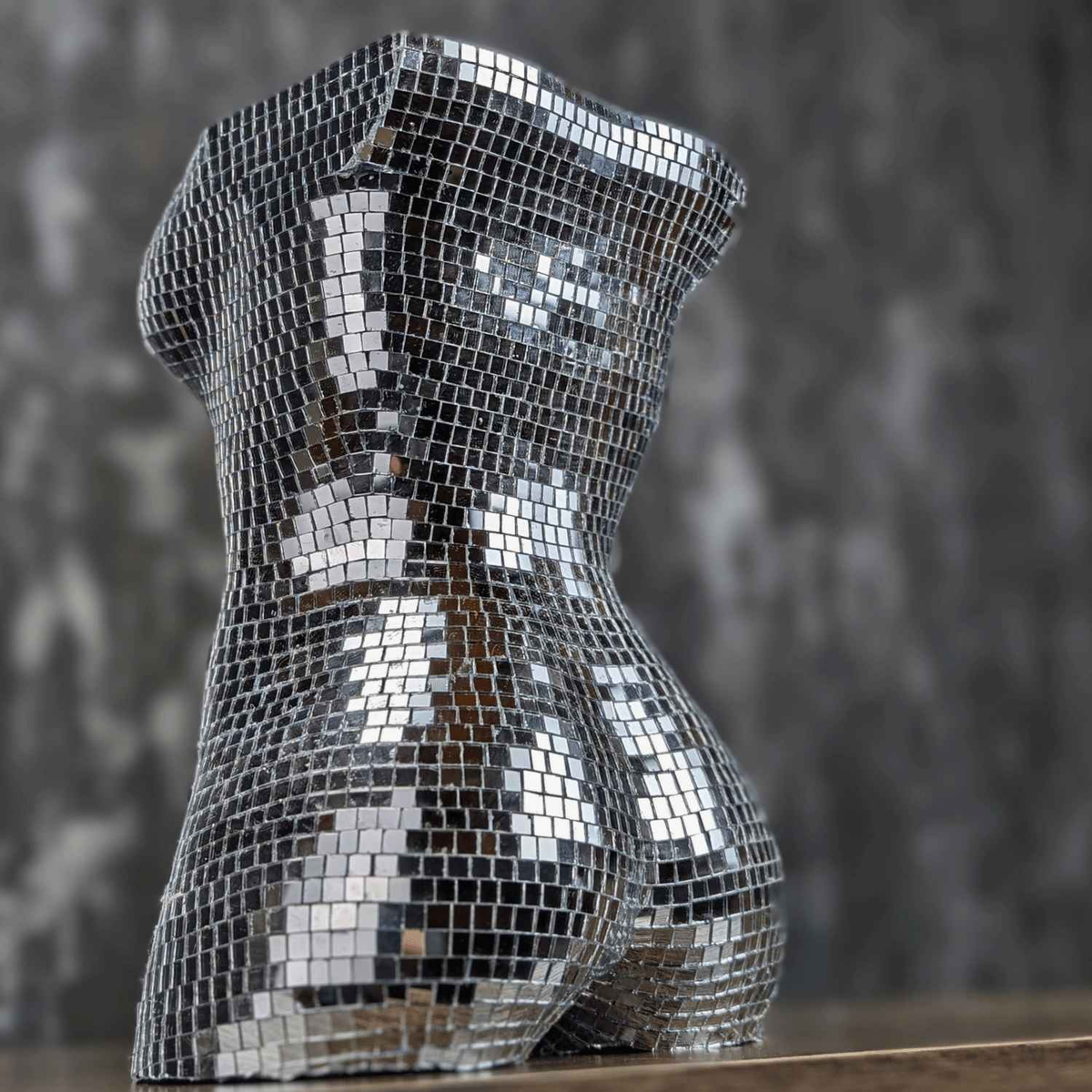 Unplanted silver mirror torso planter, three-quarter side view