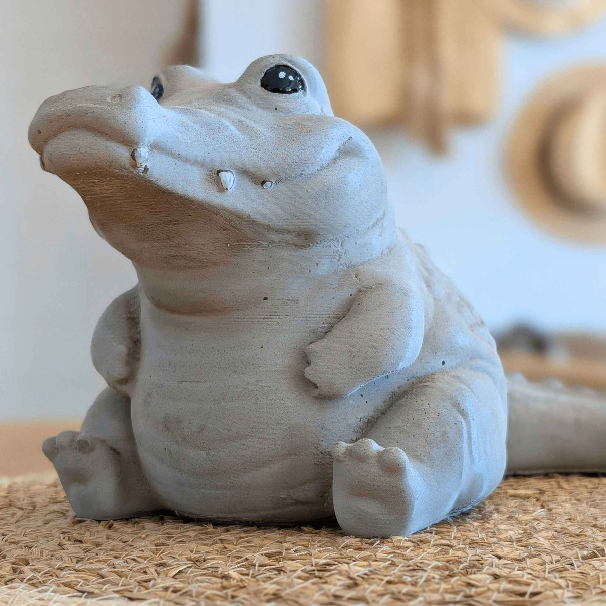Low-angle close-up showing the crocodile ornament's rounded body and feet