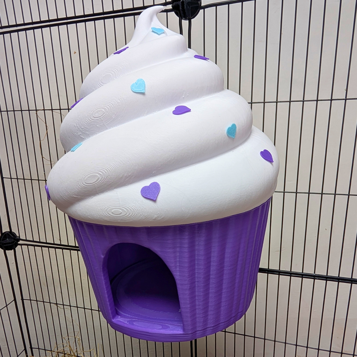 Side view of mounted cupcake rat hide showing white frosting and heart sprinkles