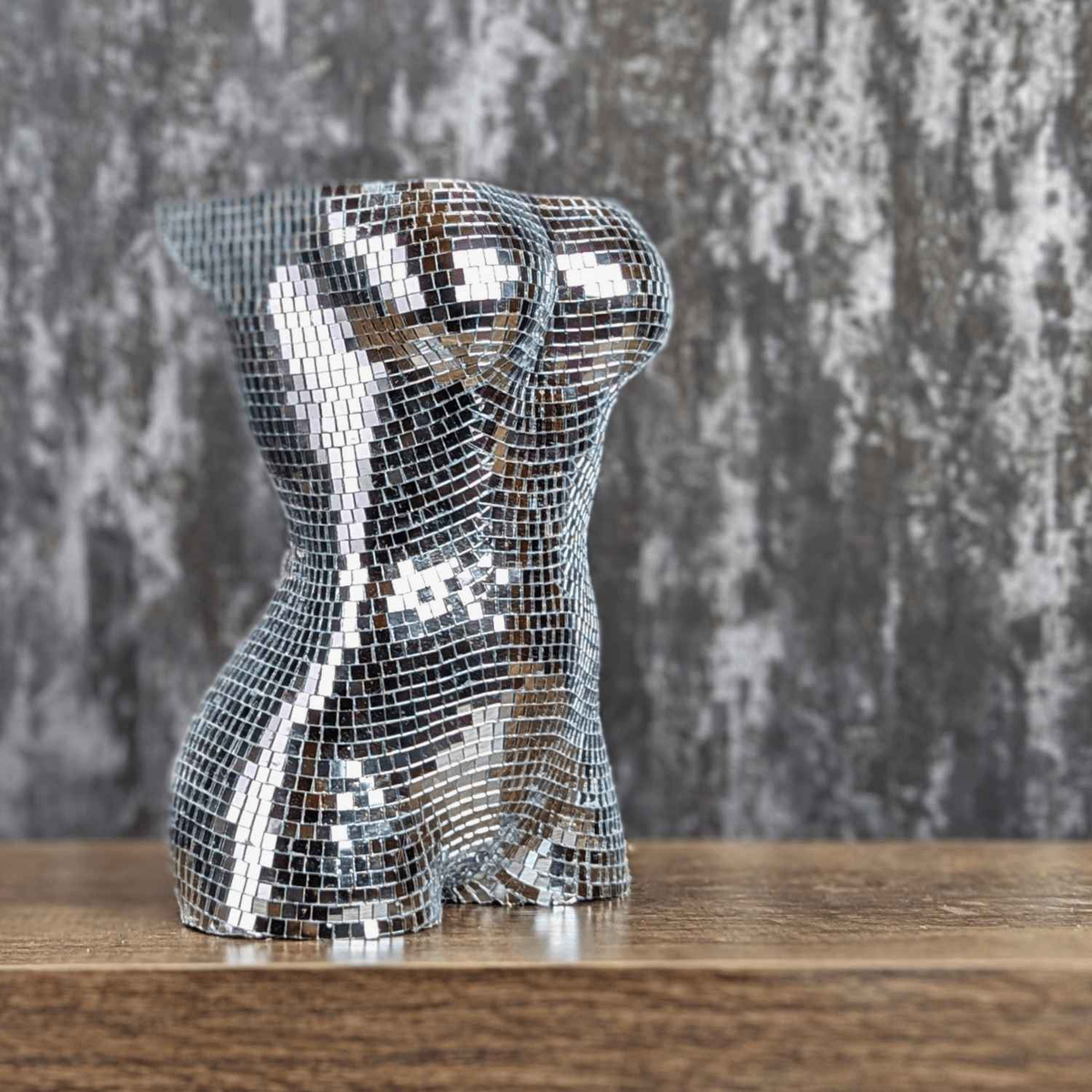Two silver mirror torso planters shown together
