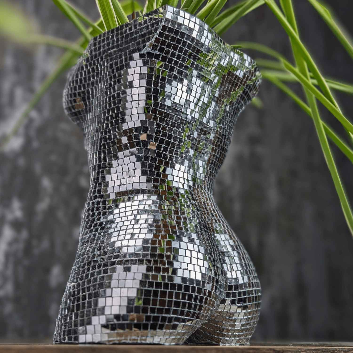Planted mirror torso planter photographed from a rear angle