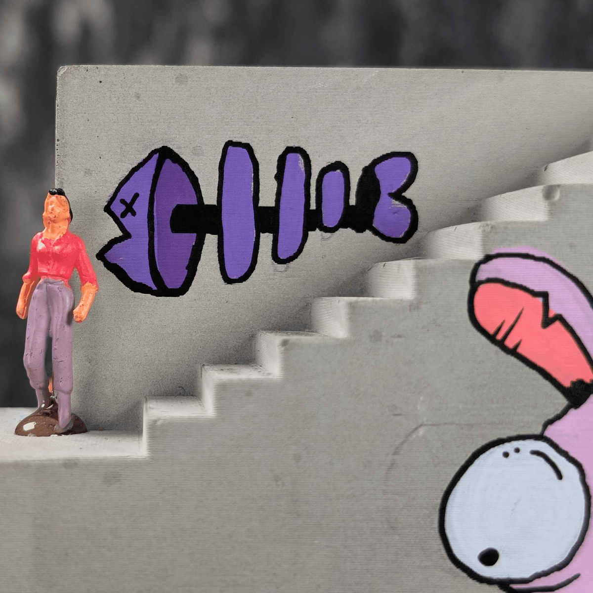 Close-up of stair detail, purple lettering and pink rabbit mural with scale figure