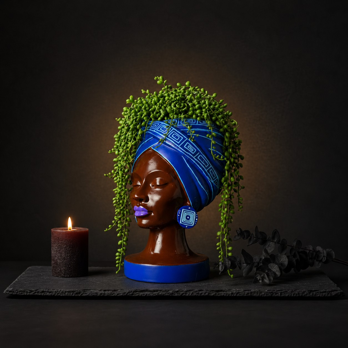 Adire Night black and gold head planter with plant and candle