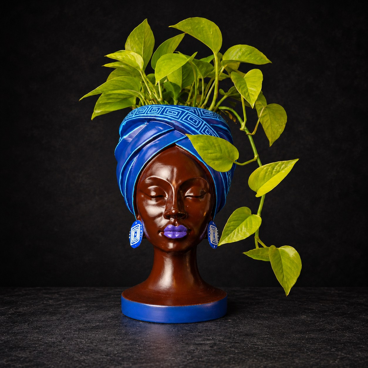 Adire Night cast stone head planter with trailing green plant by Ripleys Nest