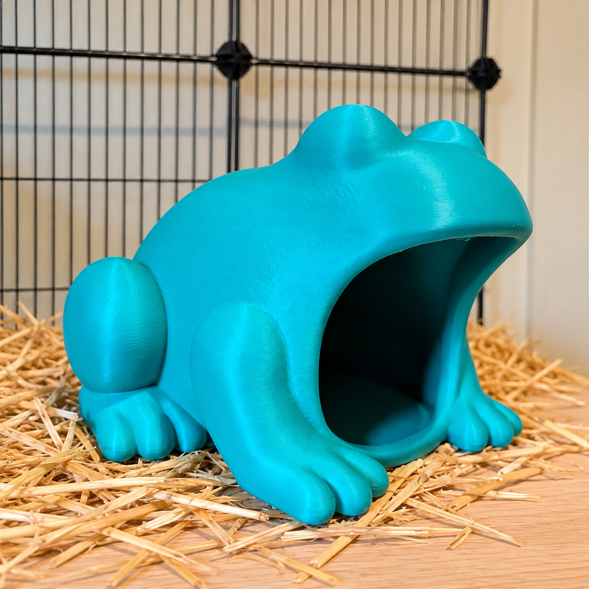 Turquoise frog hide viewed from the side with its empty front opening visible.