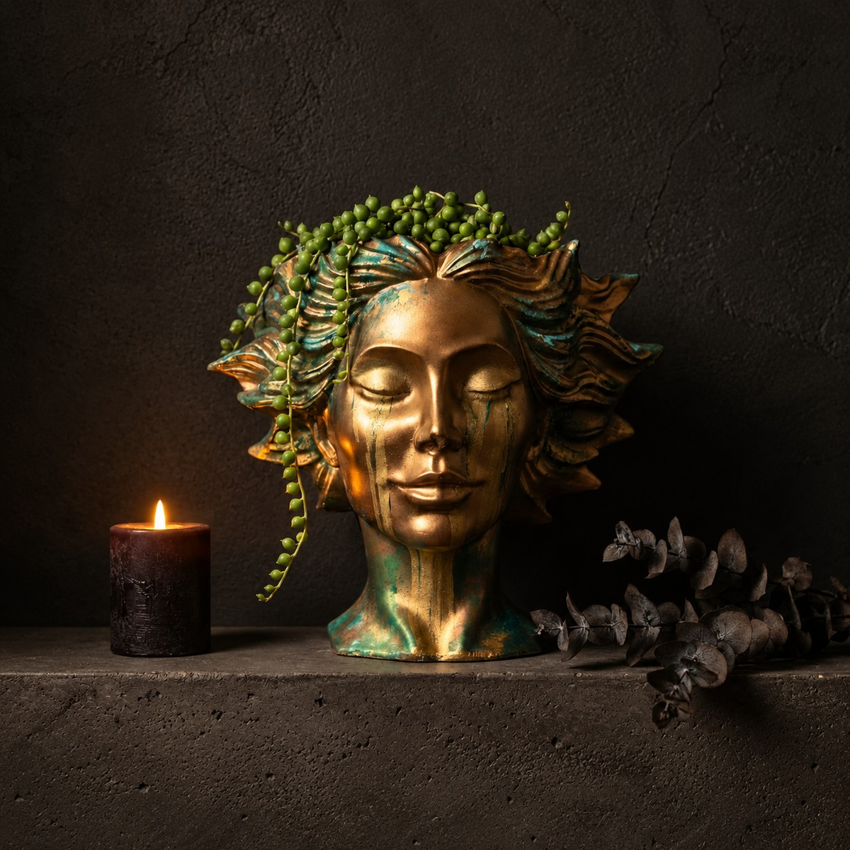 Golden Tears head planter styled on dark shelf