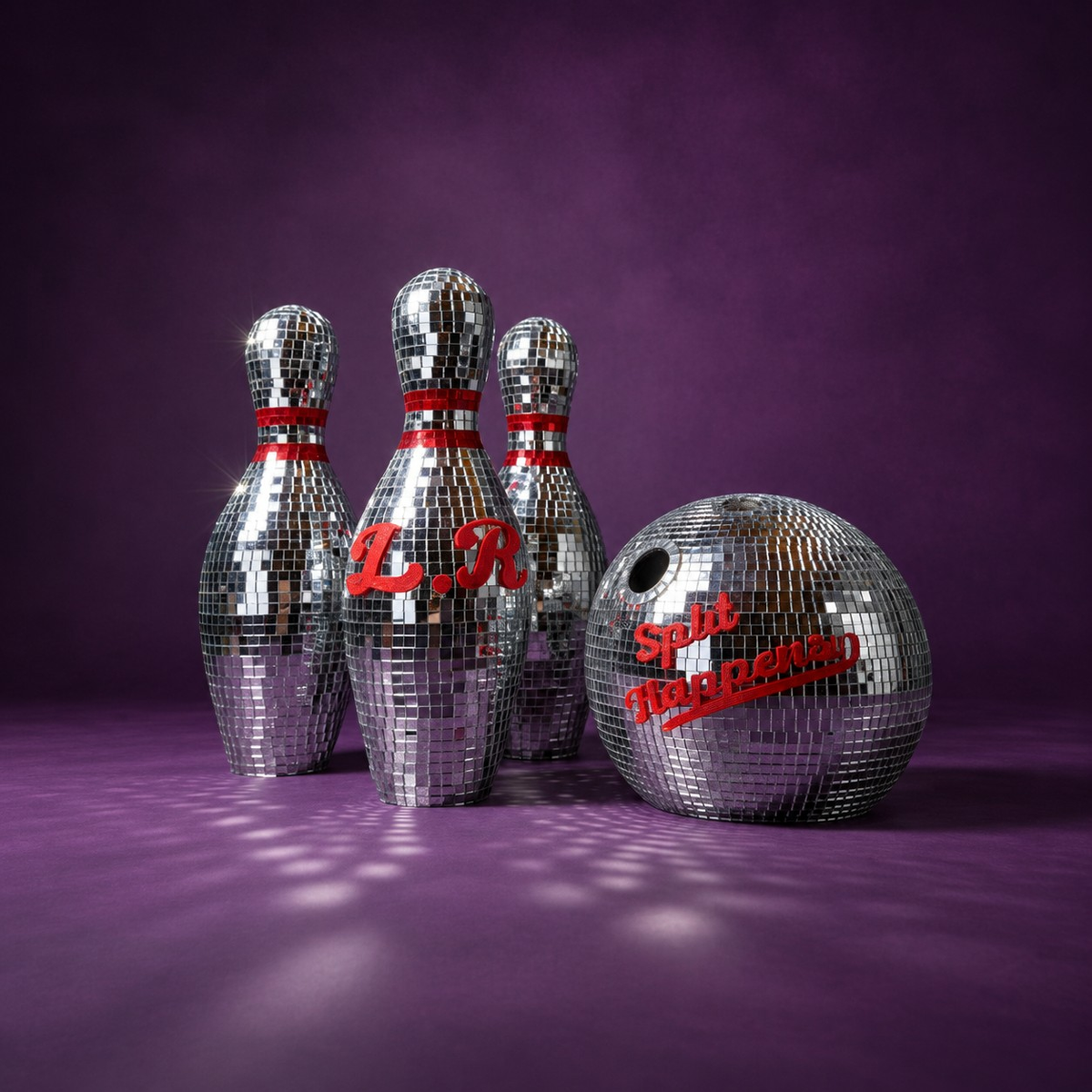 Personalised mirror bowling ball in front of three matching pins on a purple backdrop
