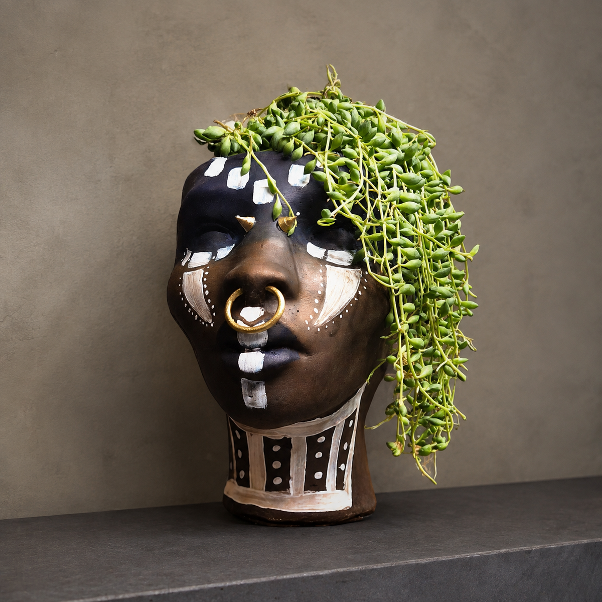African Head Planter: close view of head planter with trailing greenery