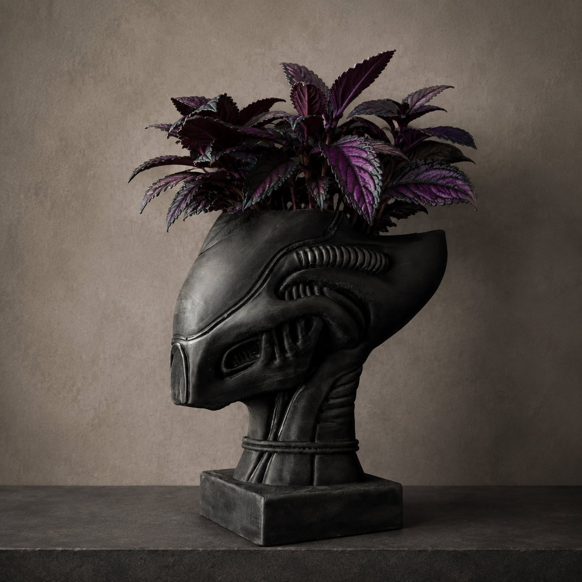 Alien Head Planter | Xenophyte Cast Stone Plant Pot, dark alien head planter with purple foliage