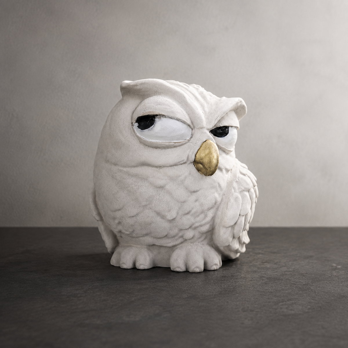 The Little Critic Owl Garden Ornament, white owl with narrowed eyes and a gold-coloured beak