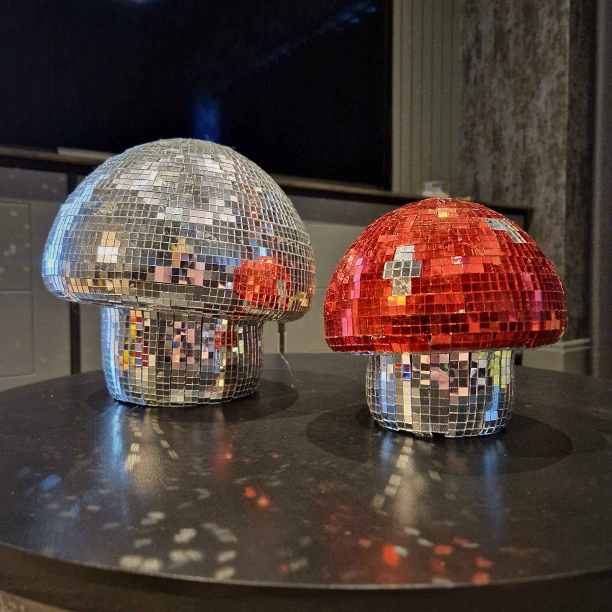 Large and small silver and cherry red disco mushroom ornaments together
